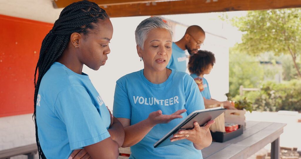 Volunteer Tech, Volunteers using a tablet to track their community service.